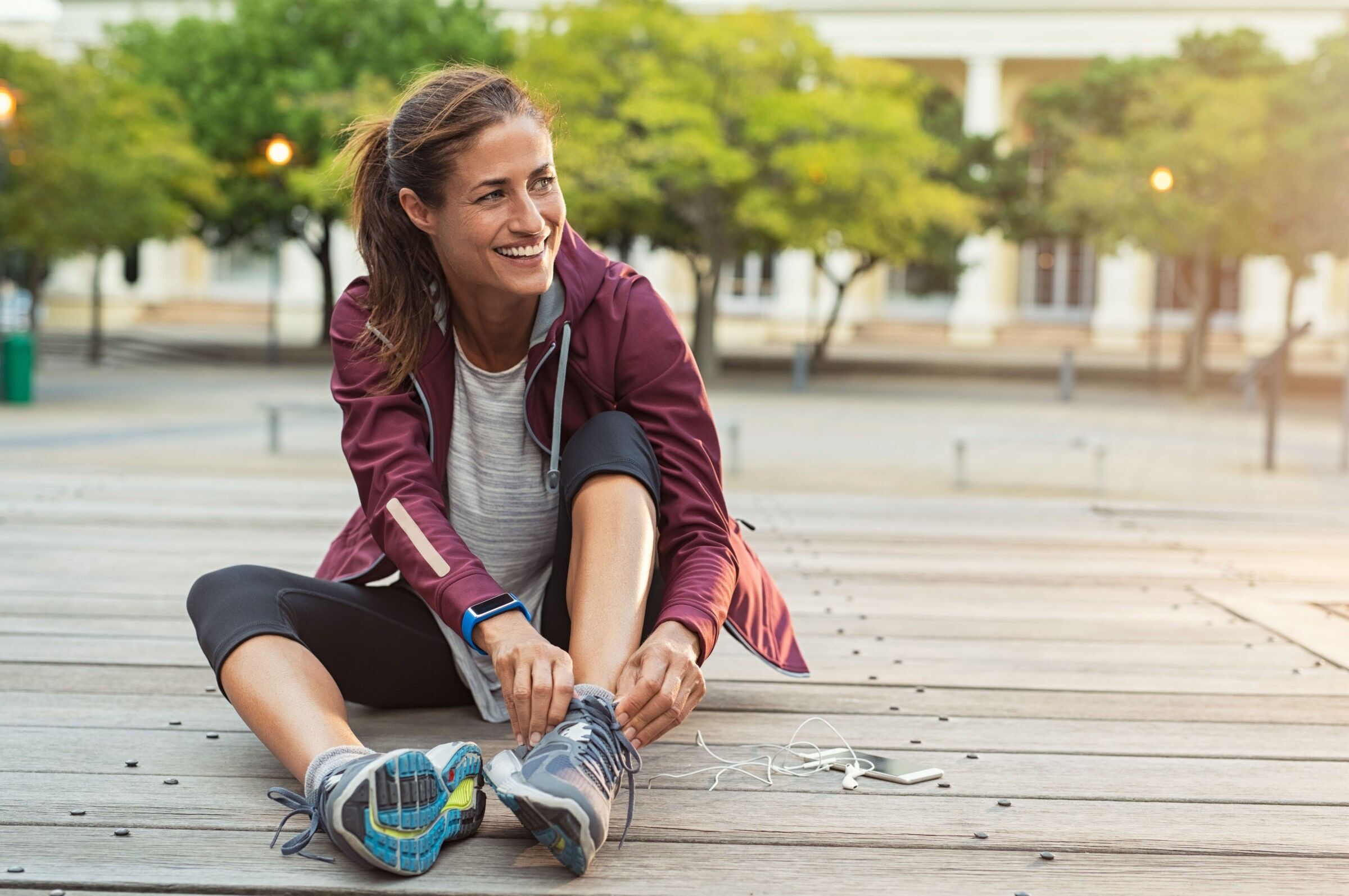 Woman tying her shoes before she goes on a run