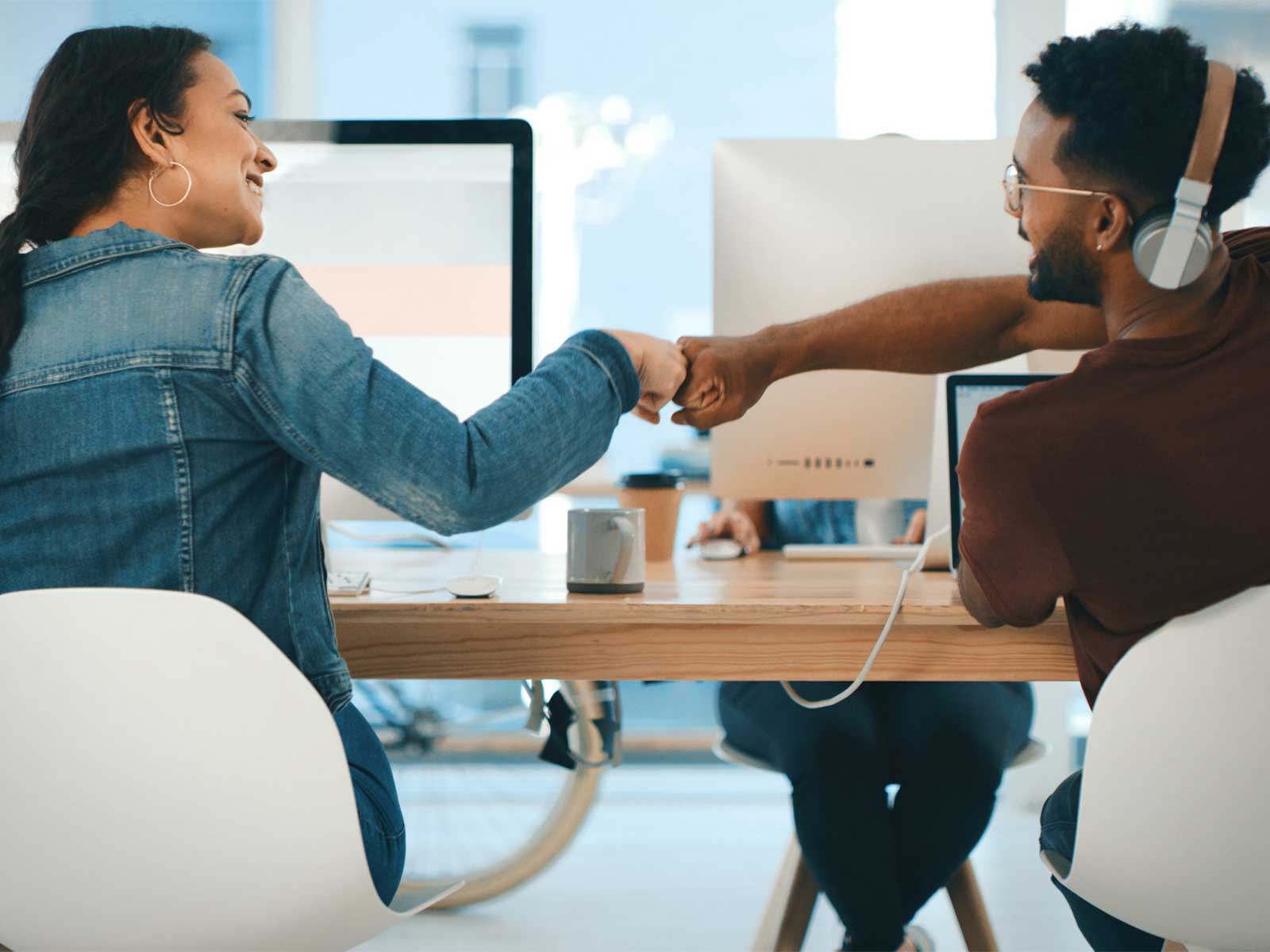 employees fist pumping after hearing about their unique employee incentive ideas for their well-being program participation.