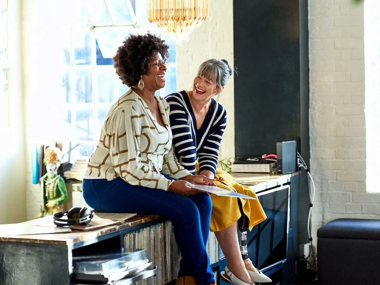 2 women smiling and laughing discussing corporate wellness program statistics