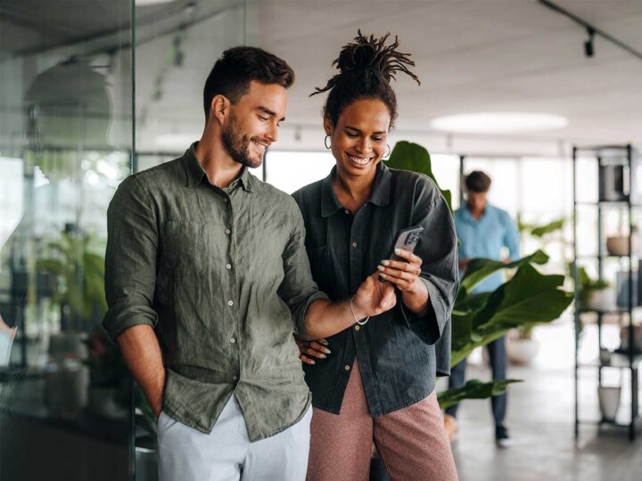 Employees looking at an employee survey on their phone