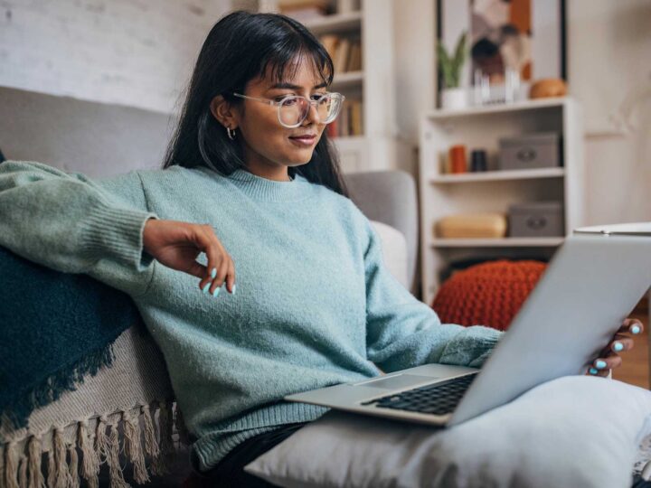 woman sitting on the floor looking at her computer