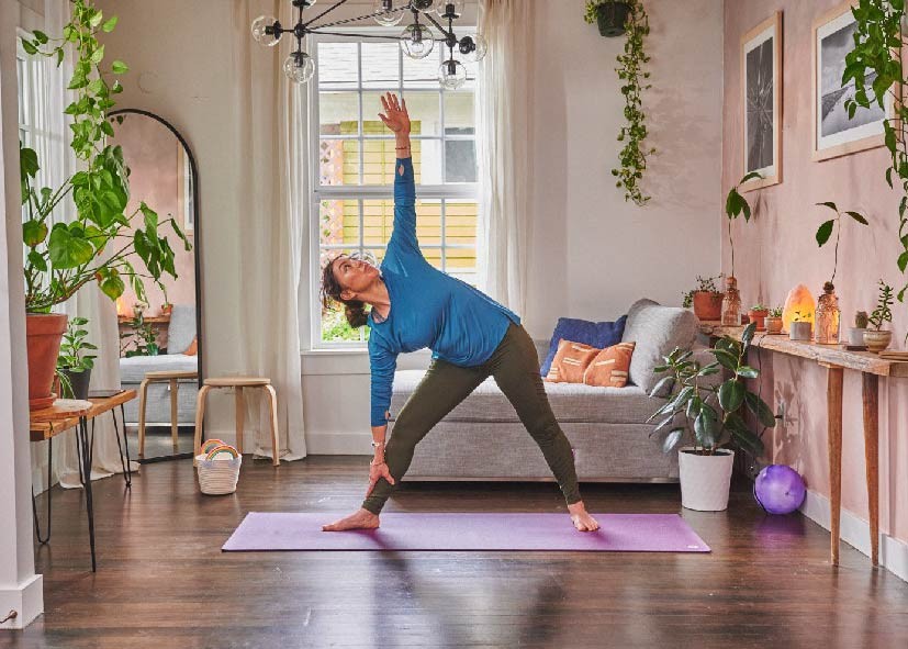 woman doing yoga in her living room