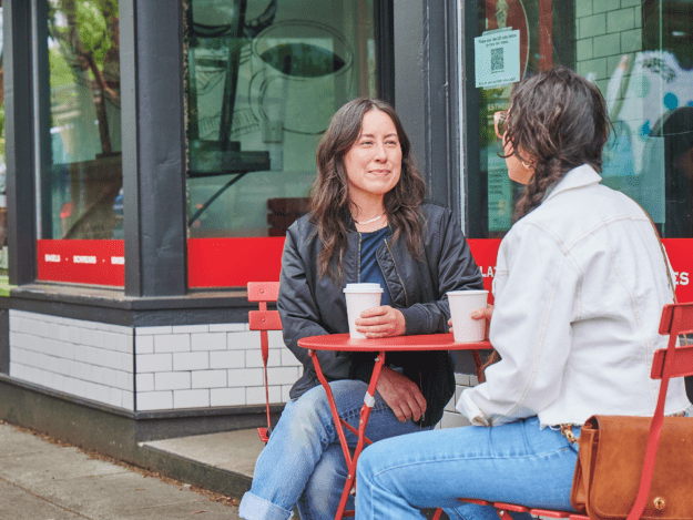Two woman having coffee outside