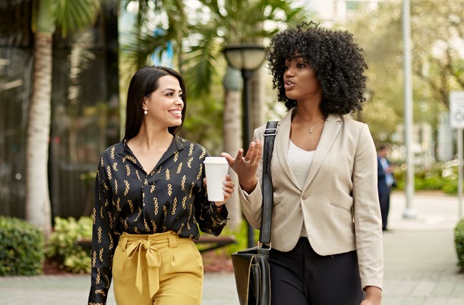 Two female employees walking together outside of work