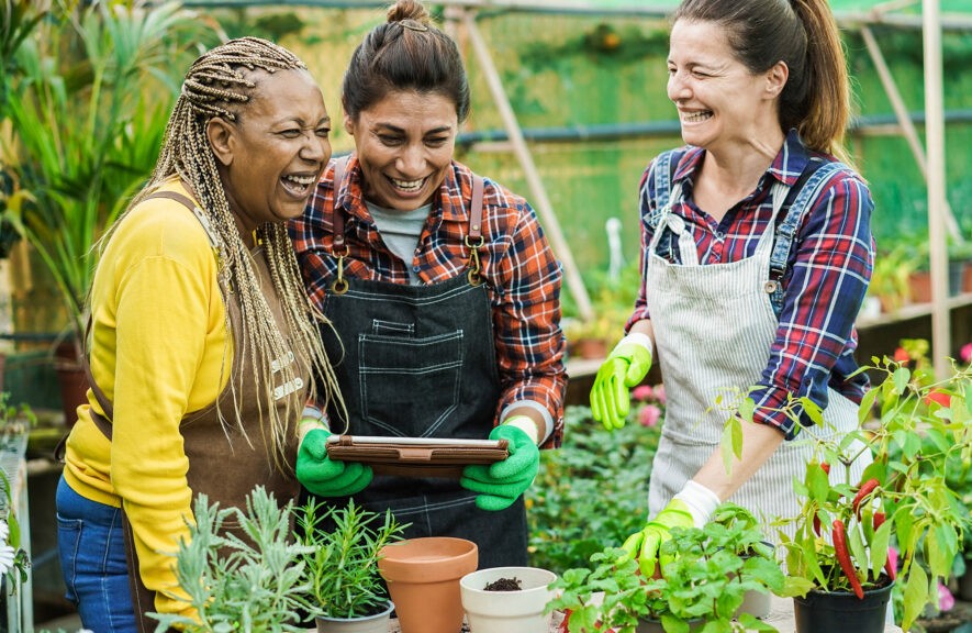 woman smiling and laughing while planting plants