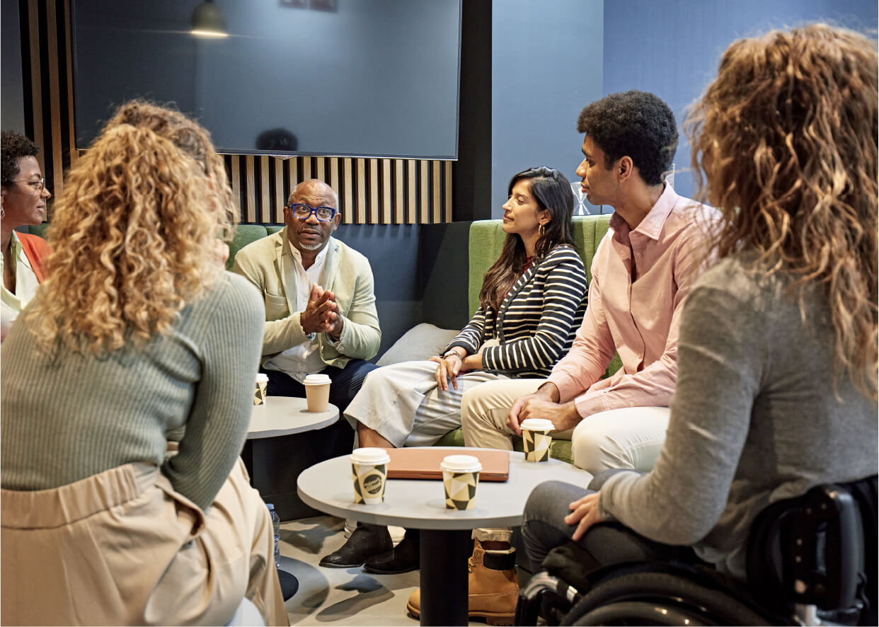 Employees discussing their well-being program.