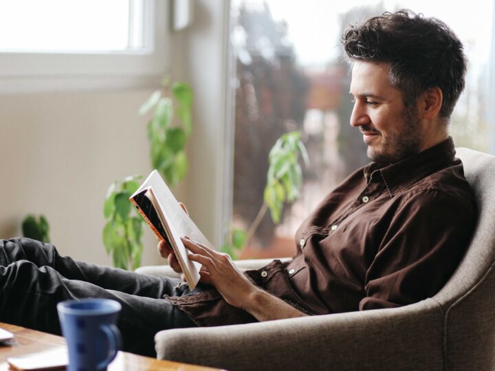 Man reading books to boost employee engagement and build a thriving culture
