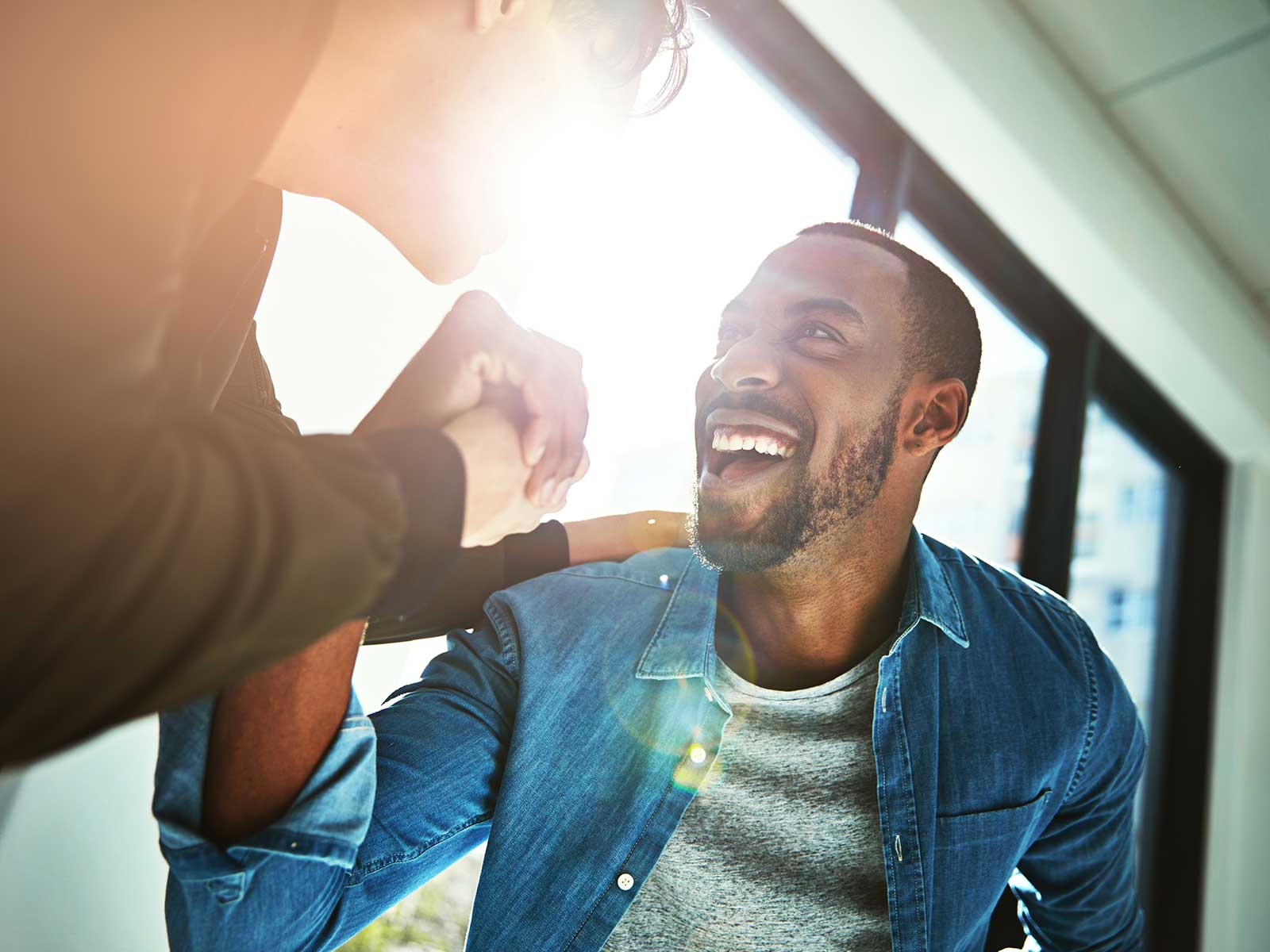 co-workers high fiving each other