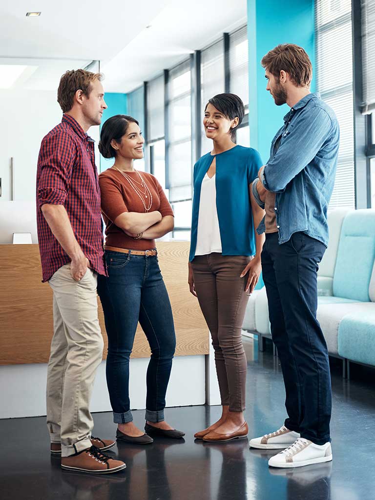employees standing and talking at work