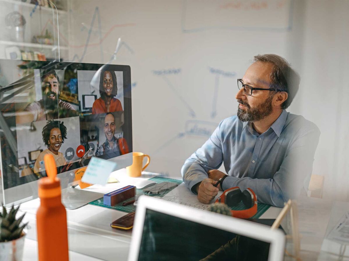 male employee sitting at his desk on a virtual call