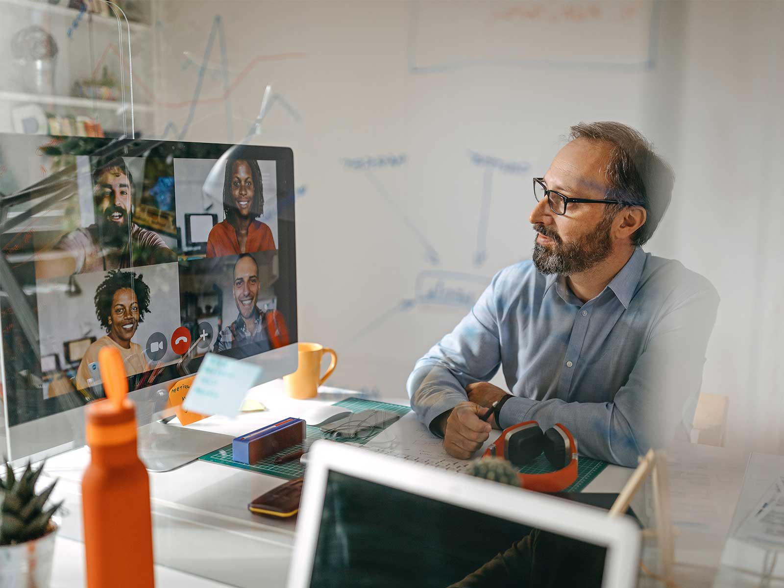 male employee sitting at his desk on a virtual call