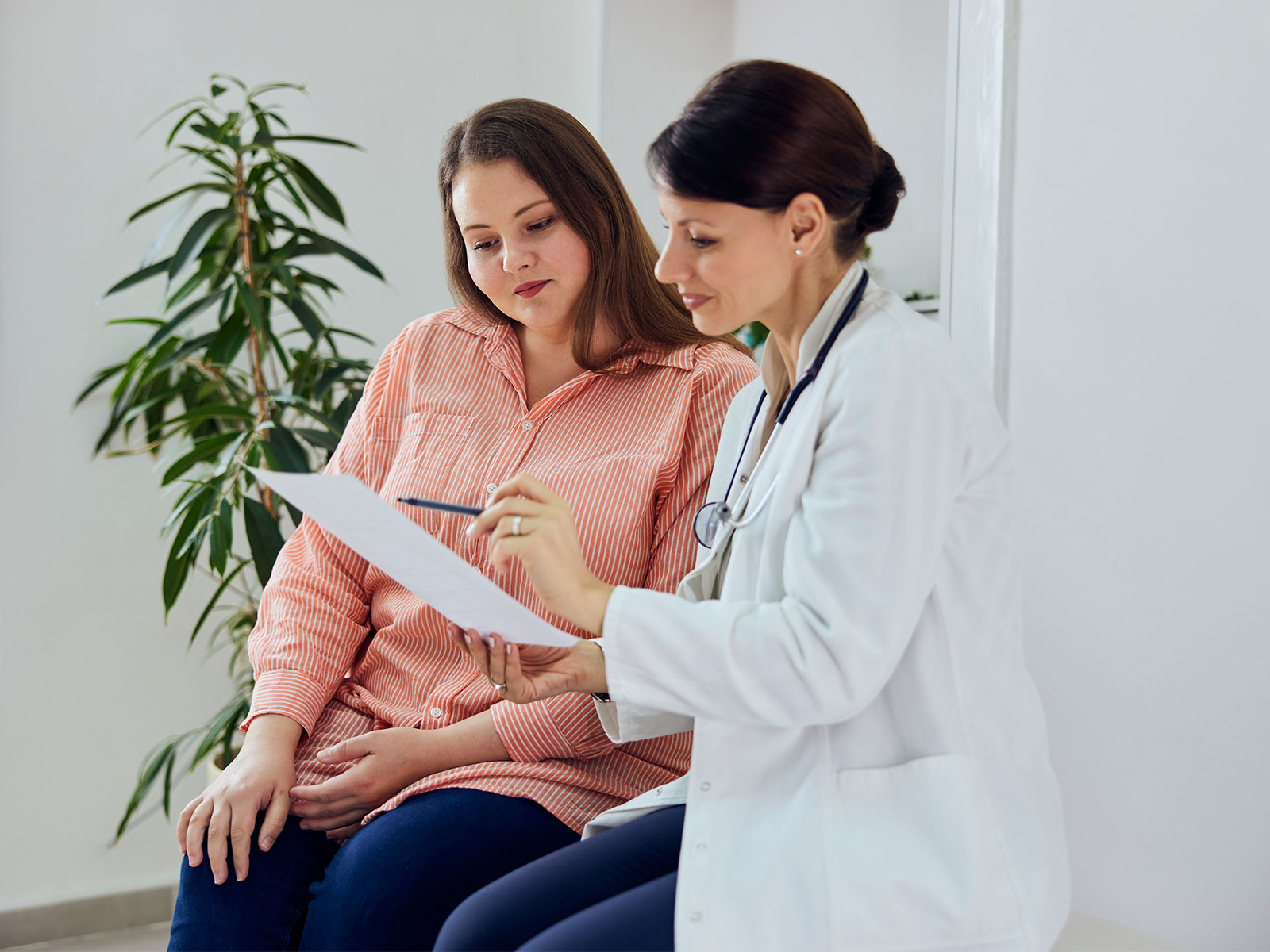 female speaking with her doctor at a preventive care check-up