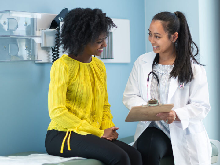 Female speaking to a physician at her preventive care appointment