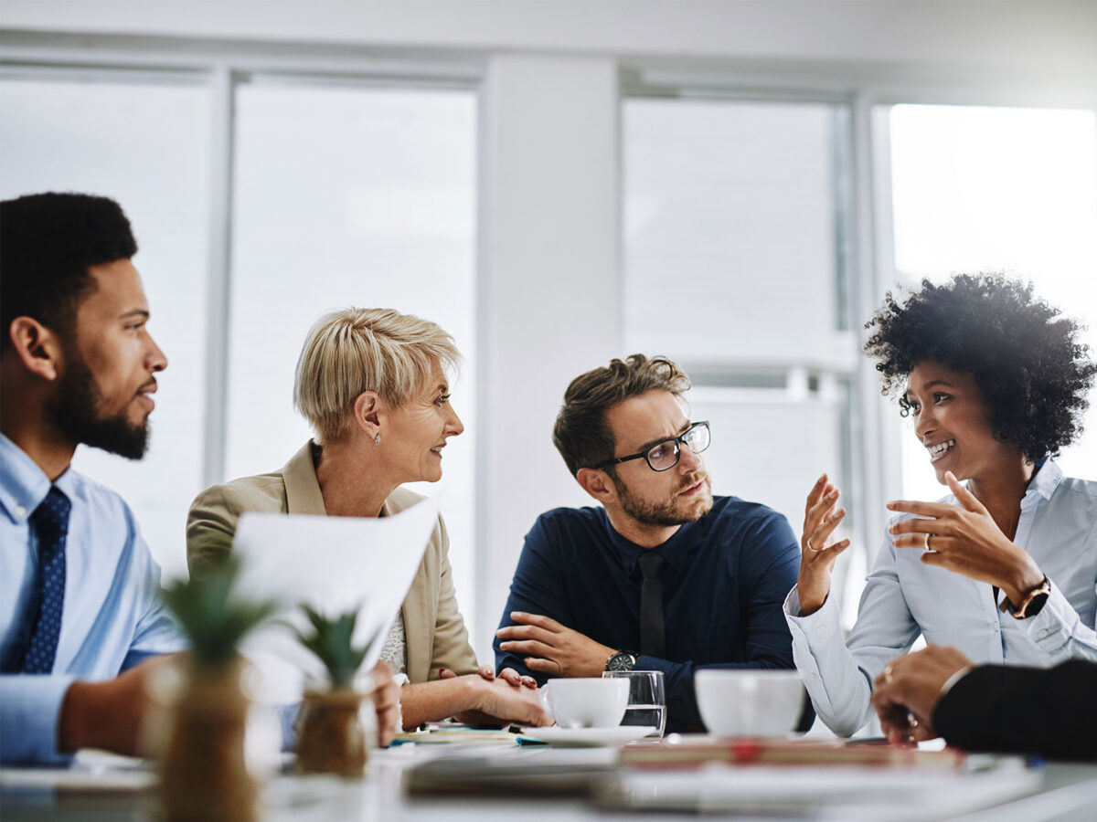 employees discussing how to measure employee engagement at a conference table