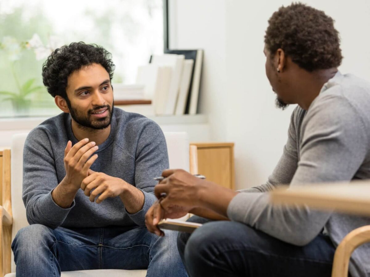 two men discussing a private matter