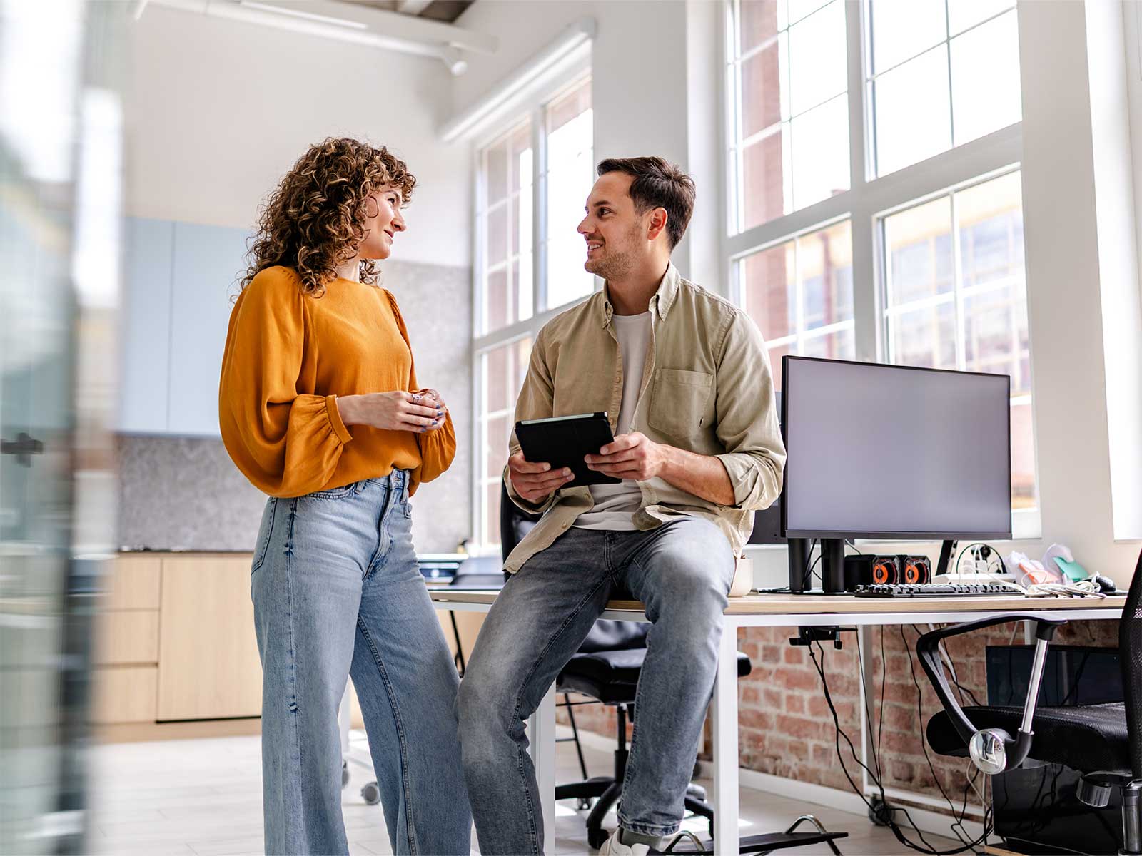 male and female employee discussing 2027 workplace well-being trends