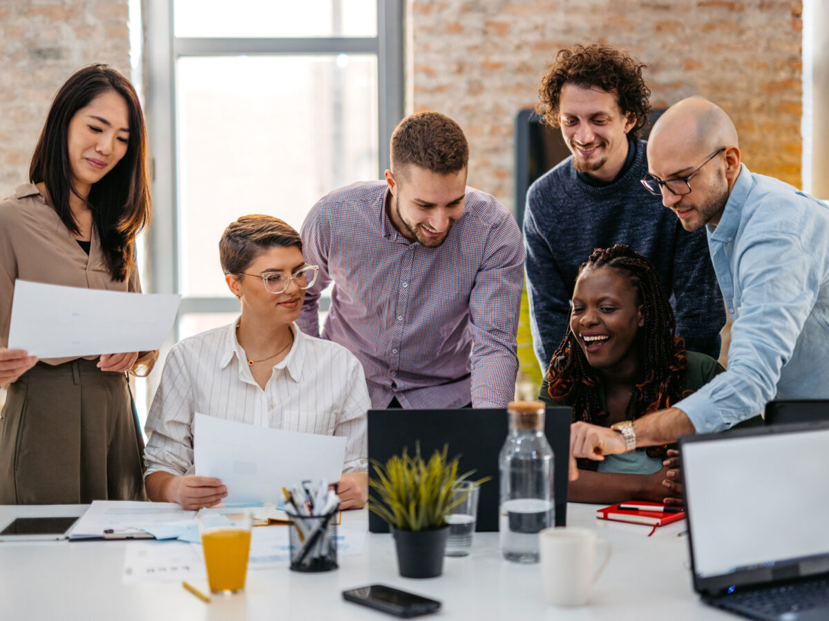 group of HR leaders at a table discussing budget-friendly employee retention tactics