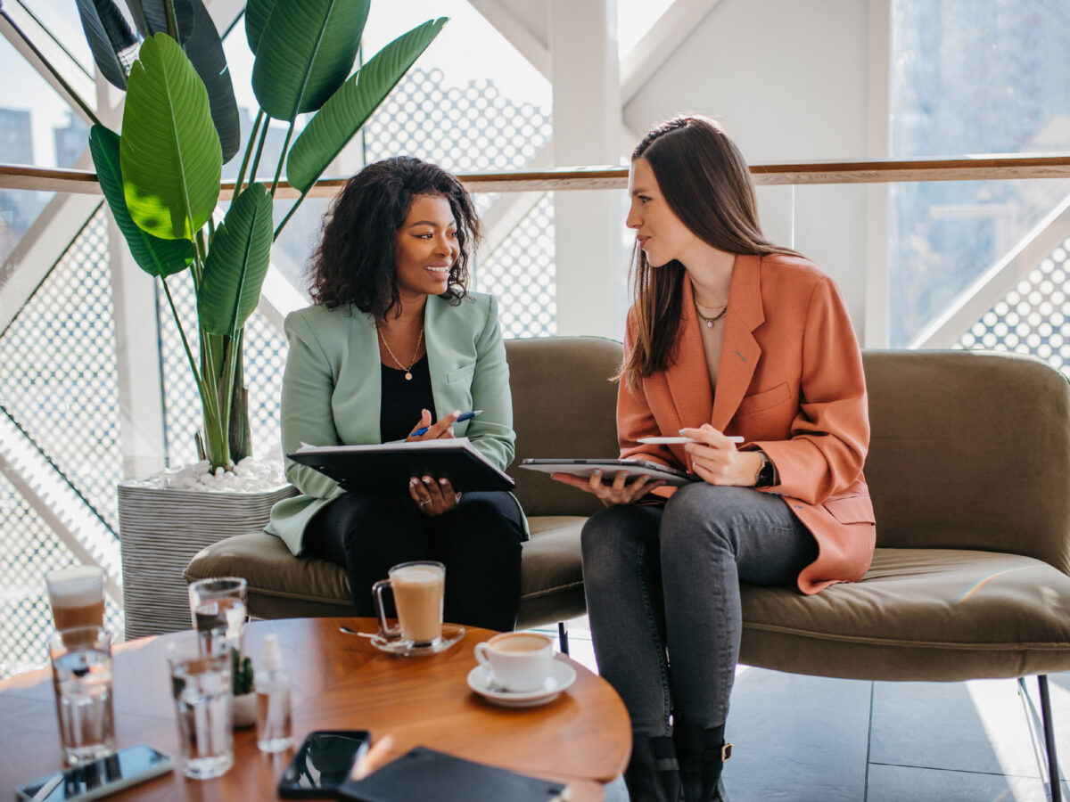Two female HR leaders discussing the state of workplace well-being