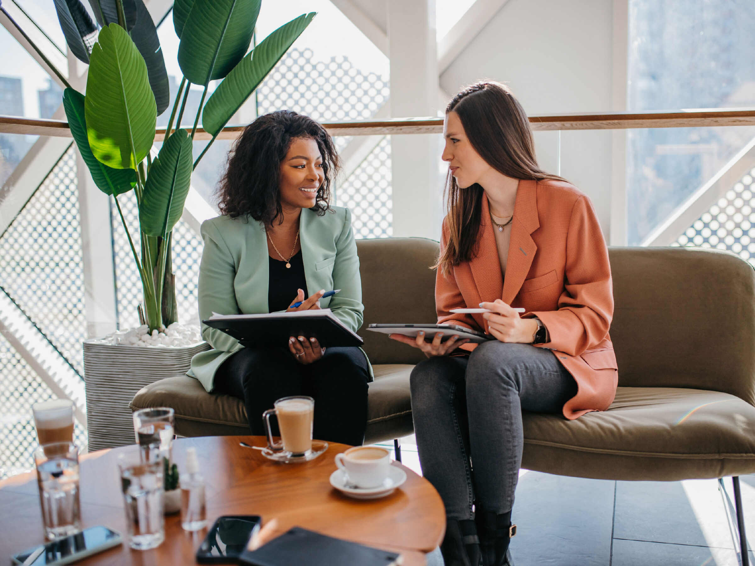 Two female HR leaders discussing the state of workplace well-being