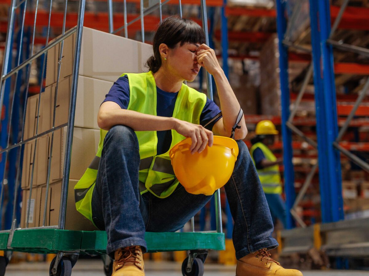 female warehouse worker looking burned out